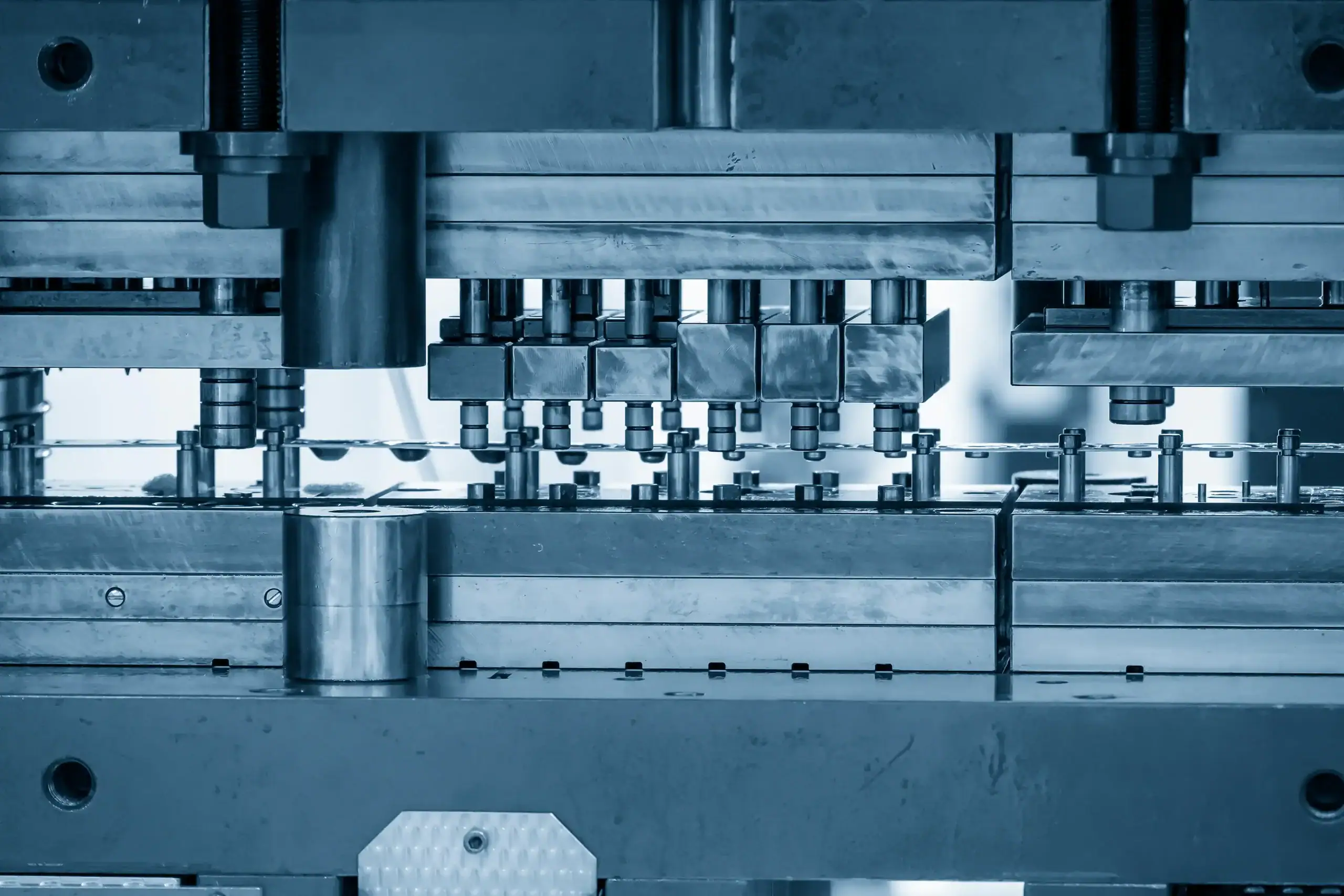 Progressive die operation making sheet metal parts for automotive industry